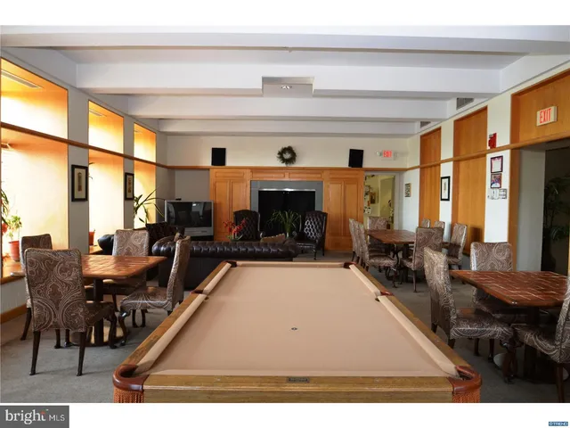a kitchen with a refrigerator stove and wooden cabinets