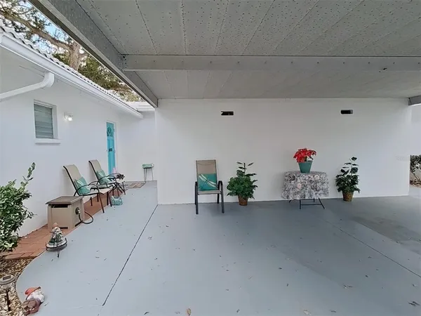 a view of a porch with furniture and a garage