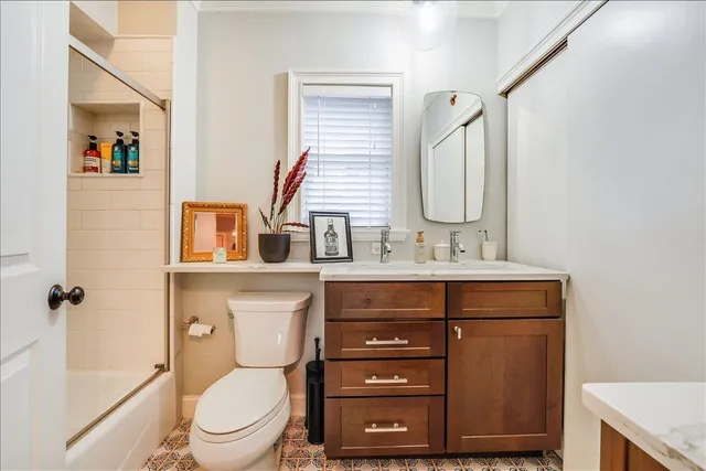 a bathroom with a toilet sink and mirror