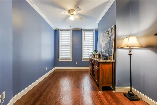 a view of room with window and wooden floor