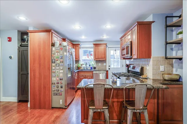 a very nice looking kitchen with a large window appliances and cabinets