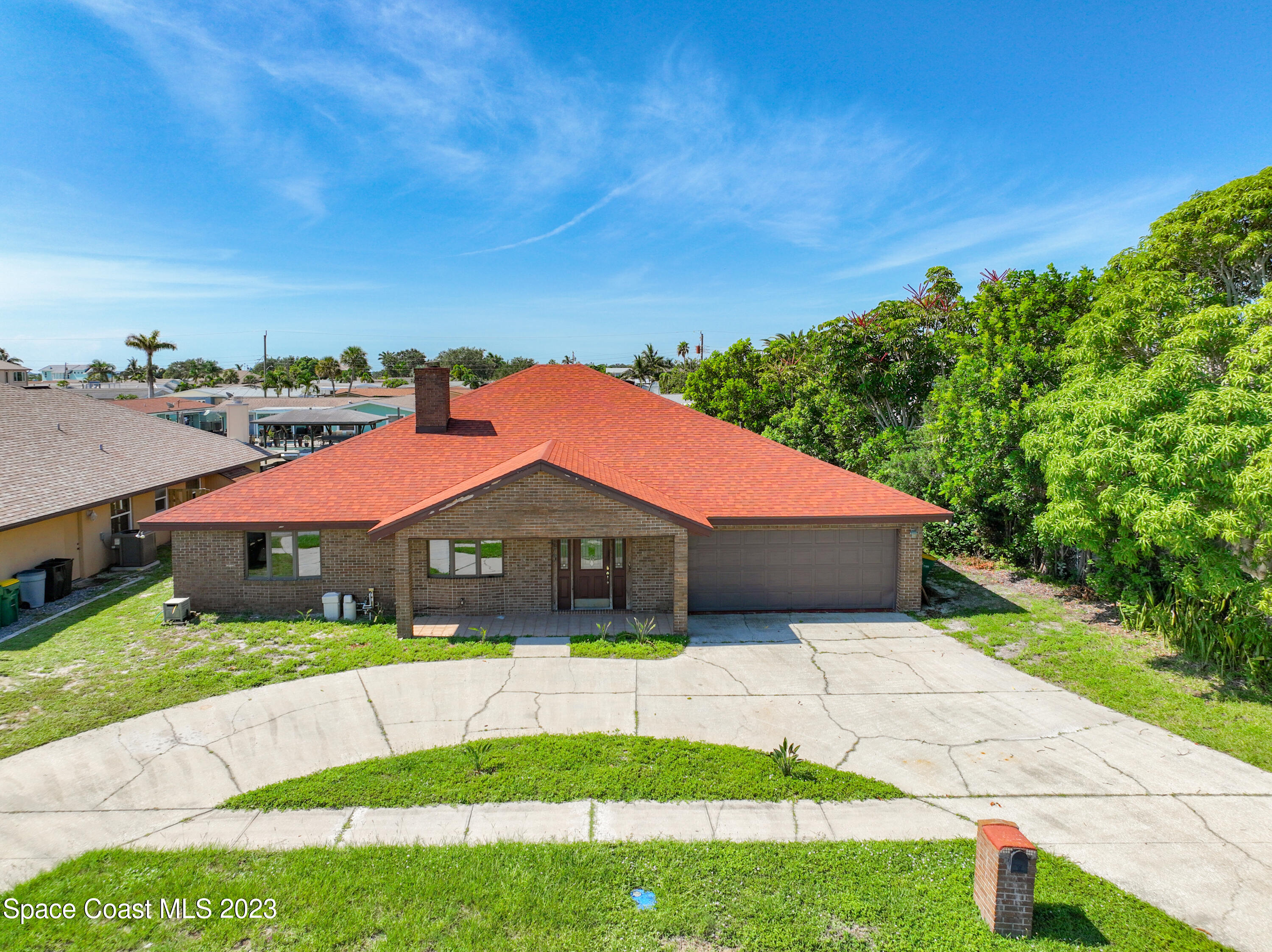 1675 East Riviera Drive Merritt Island, FL 32952 - Photo 1 of 50 a house with green field in front of it
