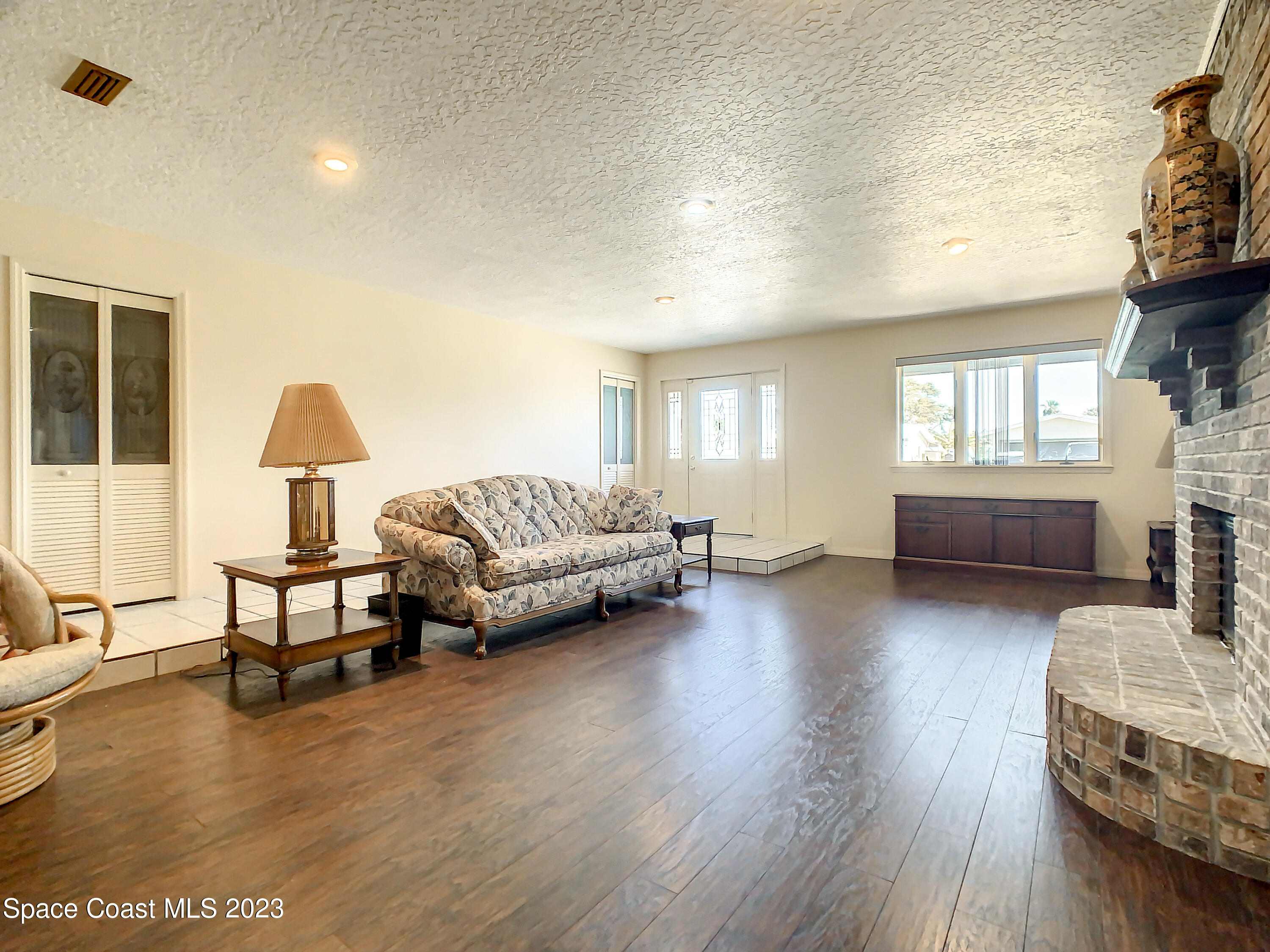 1675 East Riviera Drive Merritt Island, FL 32952 - Photo 11 of 50 a living room with furniture and a wooden floor