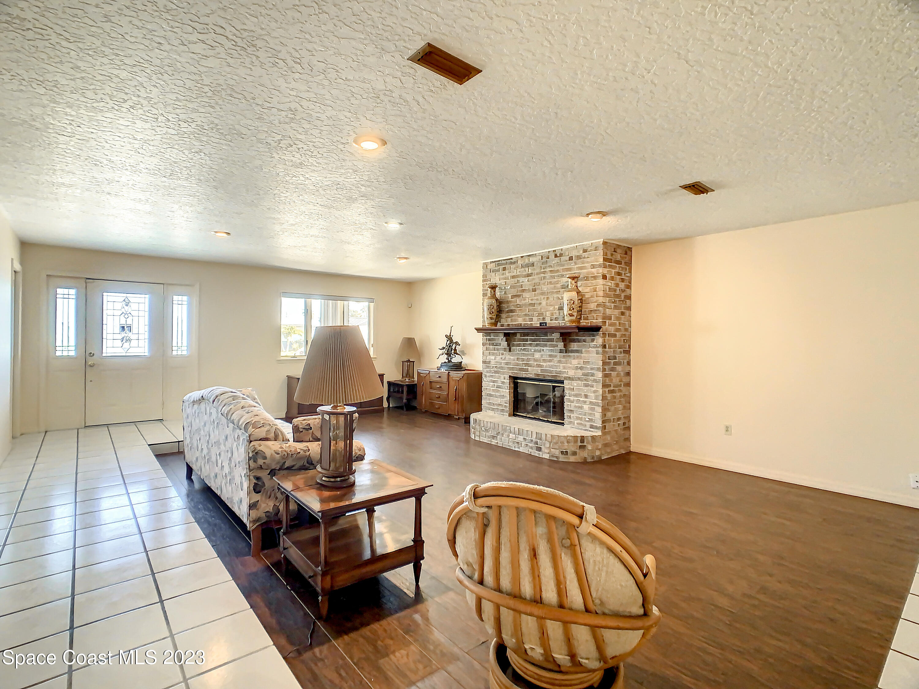 1675 East Riviera Drive Merritt Island, FL 32952 - Photo 12 of 50 a living room with furniture and a fireplace