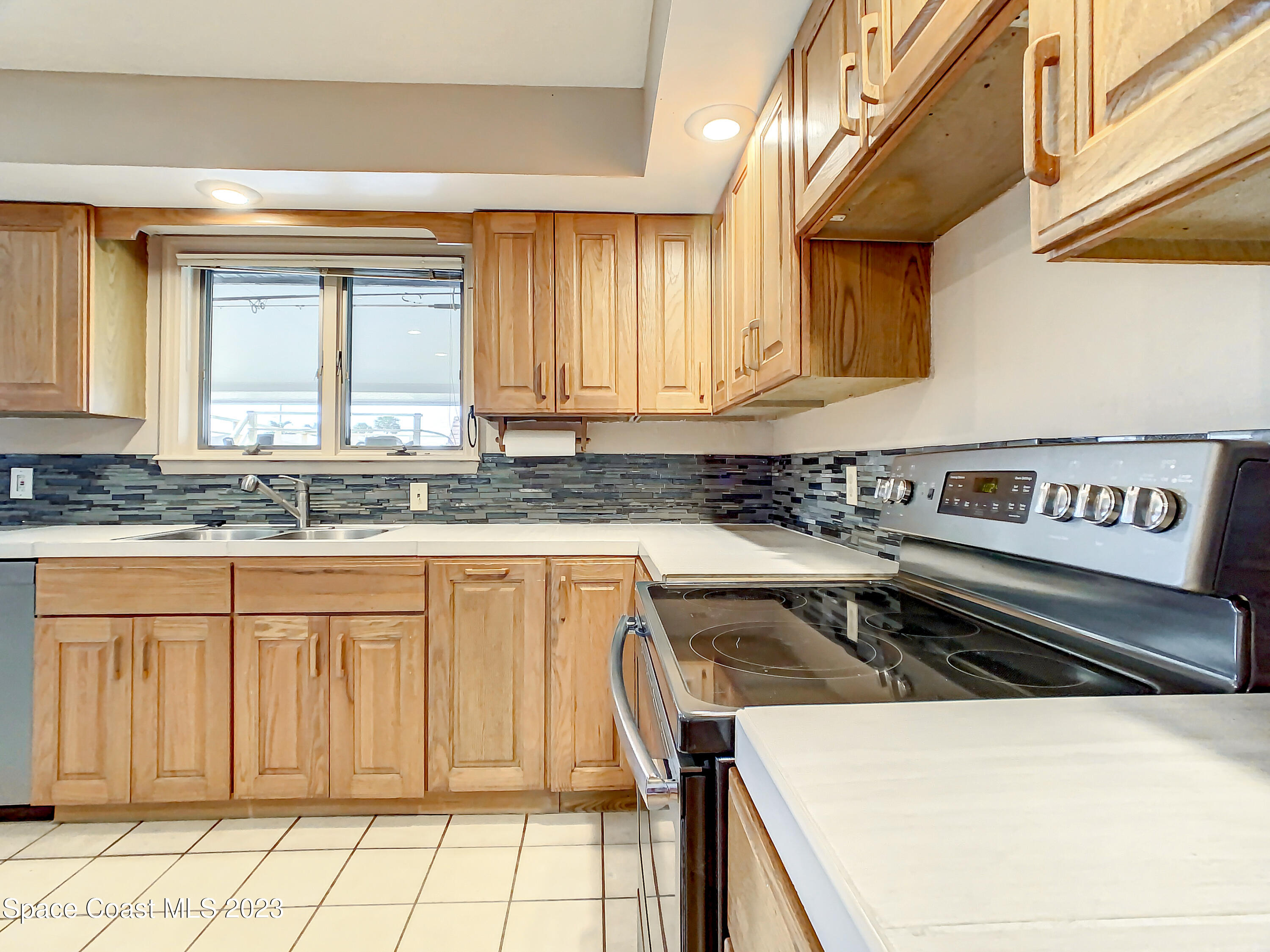 1675 East Riviera Drive Merritt Island, FL 32952 - Photo 16 of 50 a kitchen with a stove a sink and a refrigerator