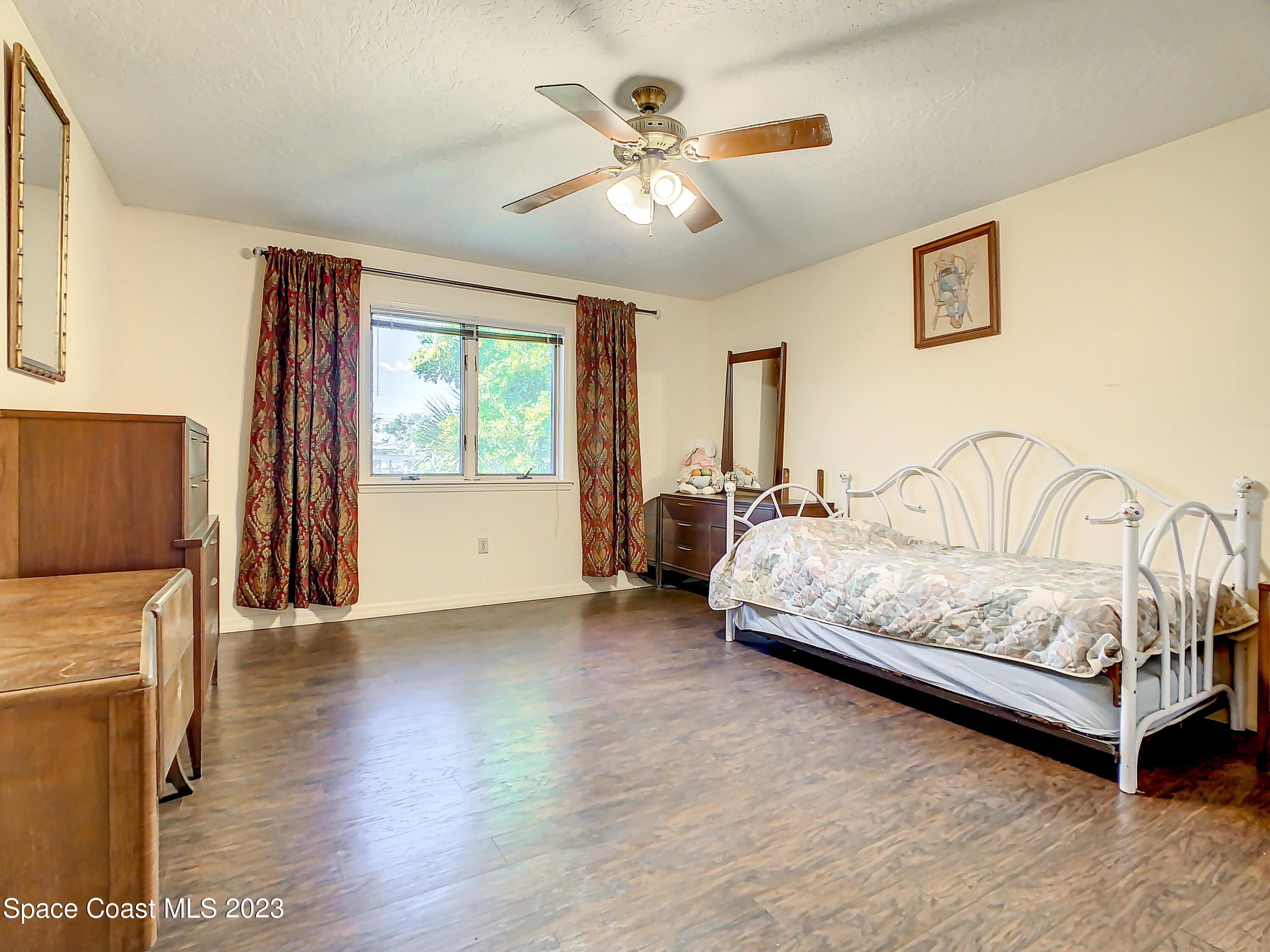 1675 East Riviera Drive Merritt Island, FL 32952 - Photo 21 of 50 a spacious bedroom with a bed and a couch