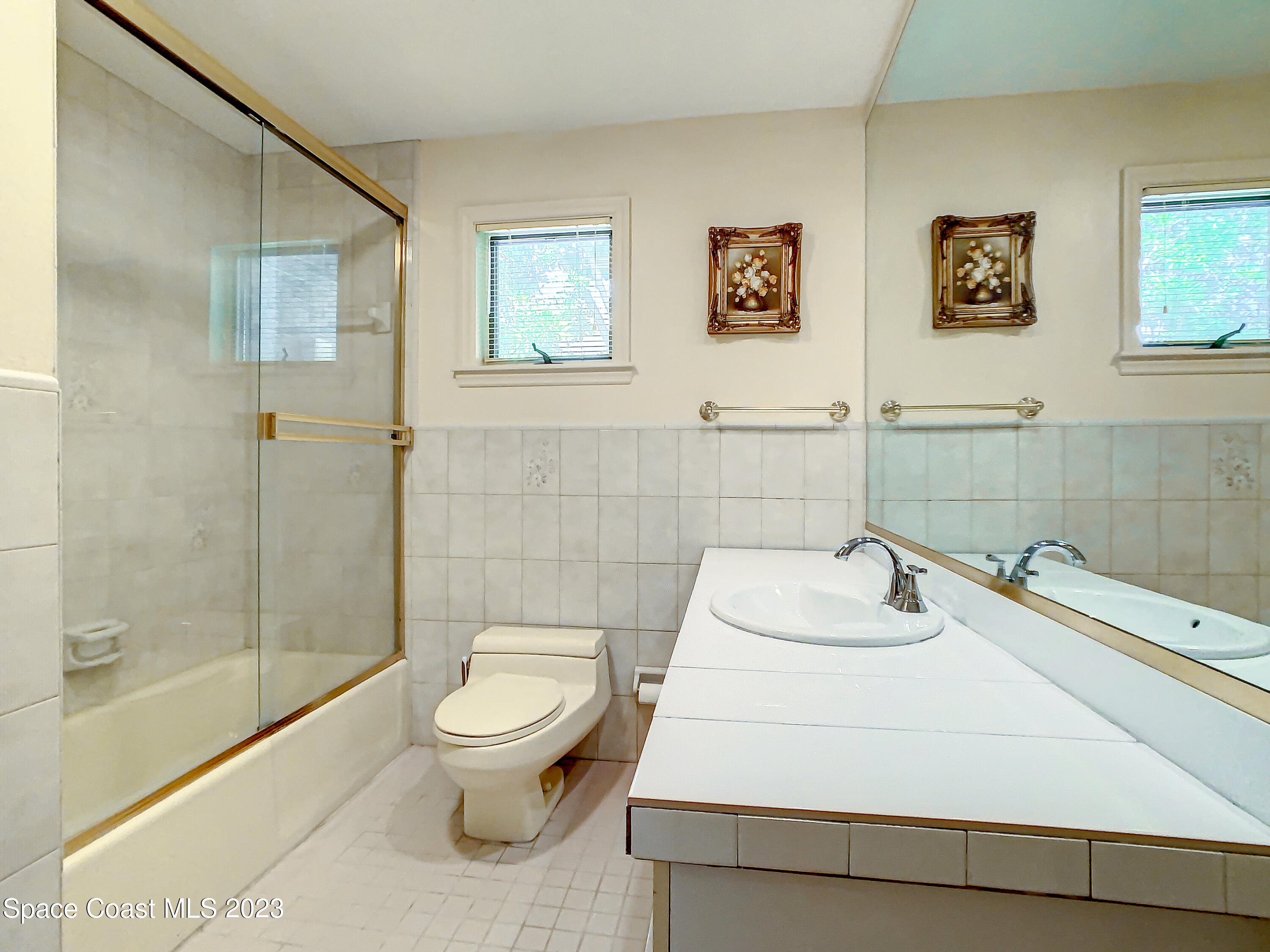 1675 East Riviera Drive Merritt Island, FL 32952 - Photo 23 of 50 a bathroom with a sink toilet and shower