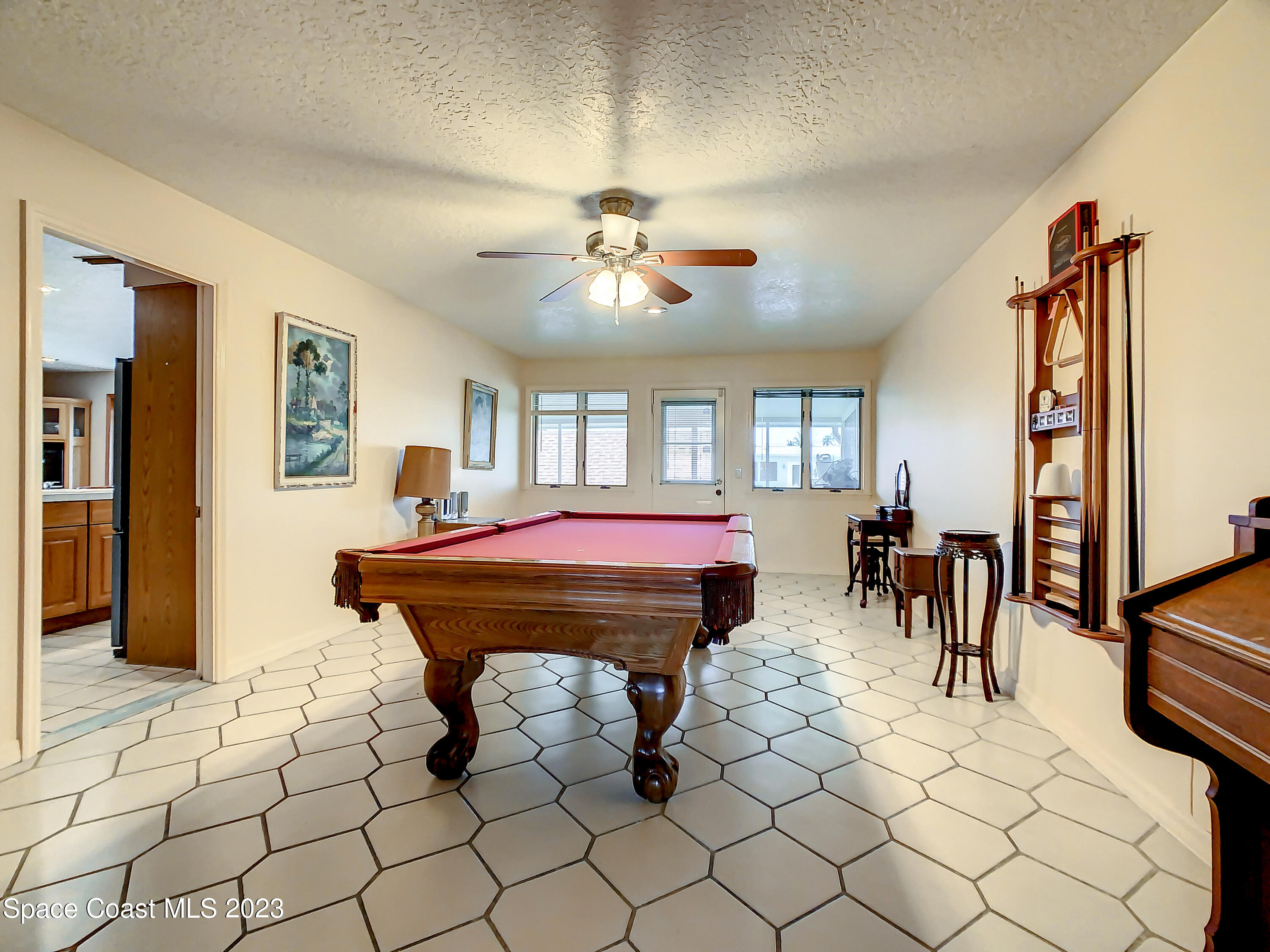 1675 East Riviera Drive Merritt Island, FL 32952 - Photo 24 of 50 a room with furniture a desk and chair with wooden floor