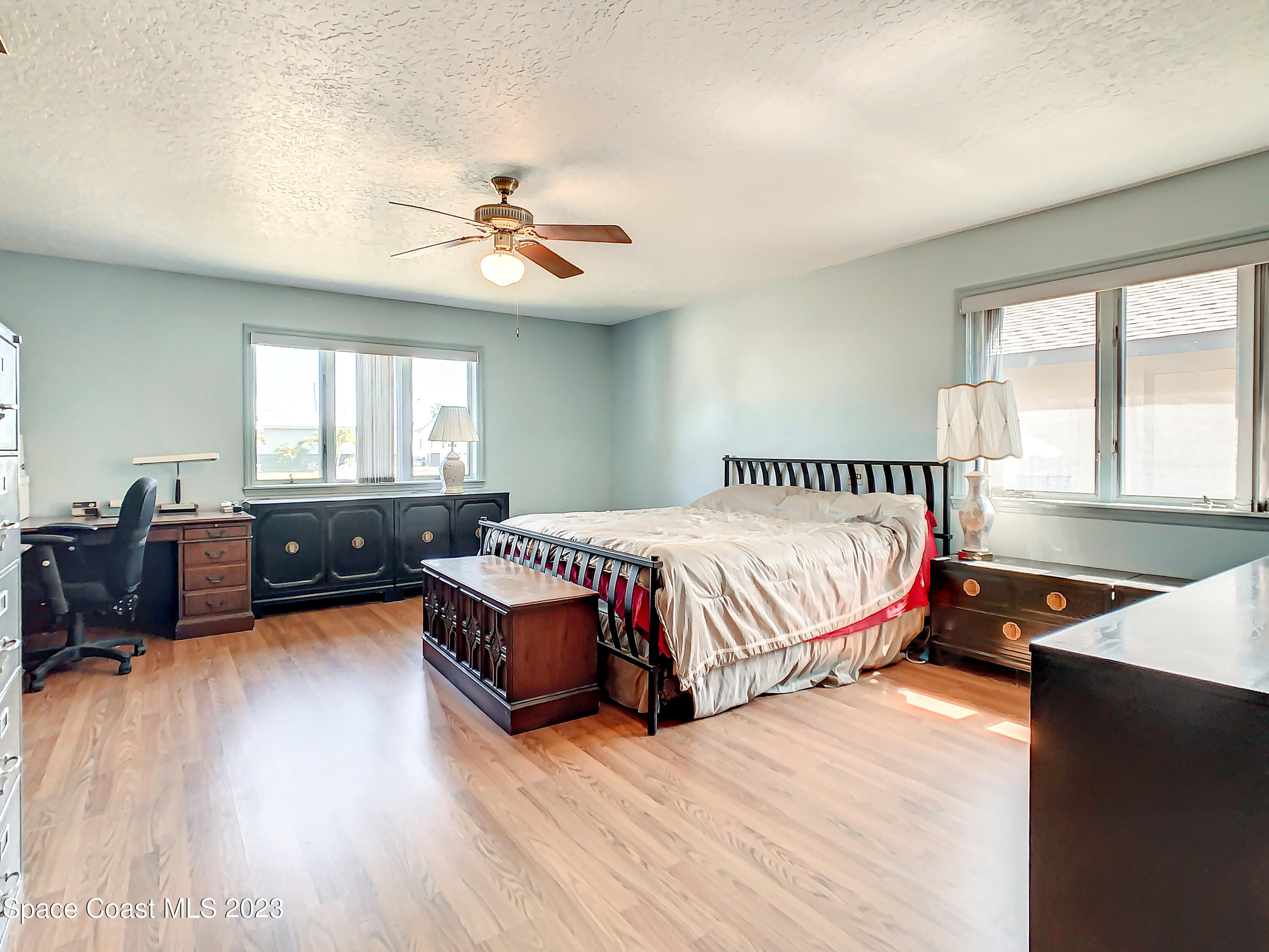 1675 East Riviera Drive Merritt Island, FL 32952 - Photo 28 of 50 a spacious bedroom with a bed and a chandelier