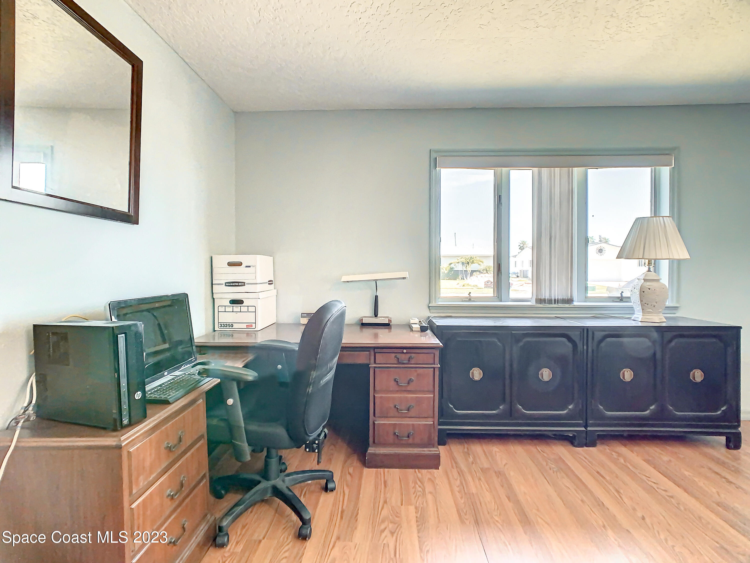 1675 East Riviera Drive Merritt Island, FL 32952 - Photo 29 of 50 a view of a workspace with furniture and a window