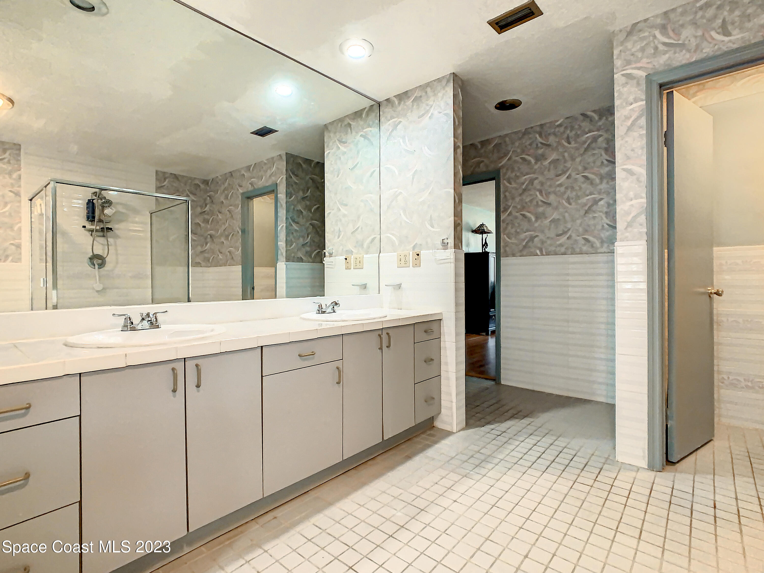 1675 East Riviera Drive Merritt Island, FL 32952 - Photo 33 of 50 a spacious bathroom with a double vanity sink a mirror and a shower