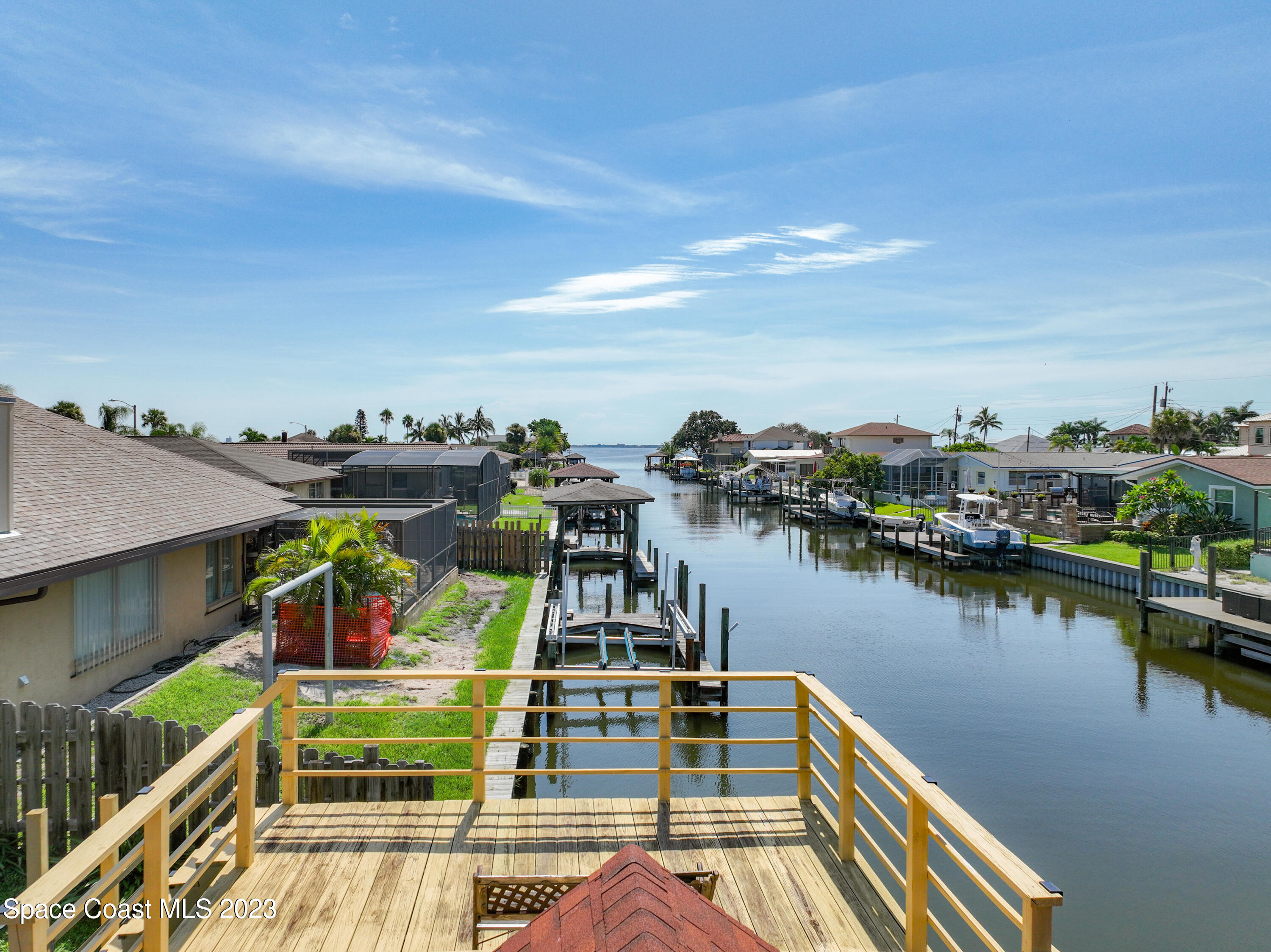 1675 East Riviera Drive Merritt Island, FL 32952 - Photo 46 of 50 a view of a lake with boats and trees in the background
