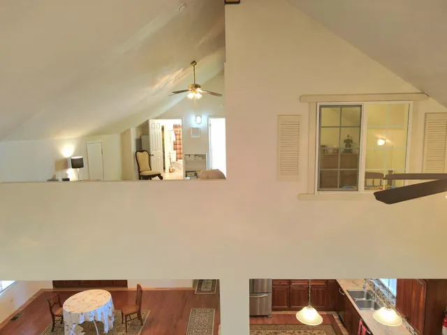 a view of a livingroom with workspace and a window