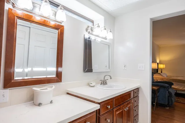a kitchen with a table chairs refrigerator and microwave