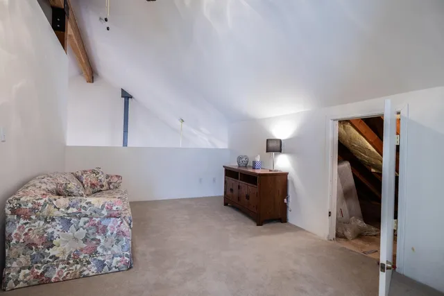 a view of a house with a small yard and wooden fence