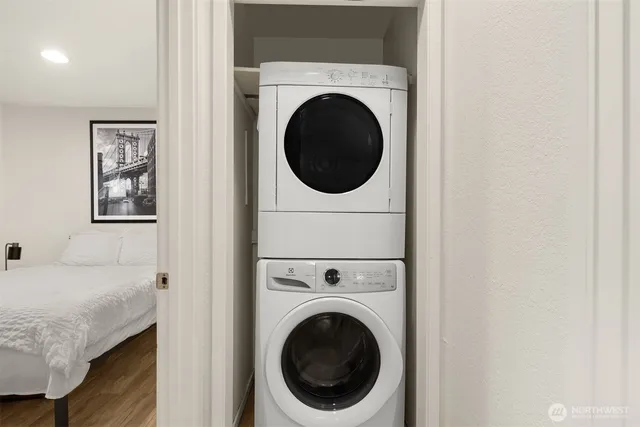 a view of a bedroom with washer and dryer