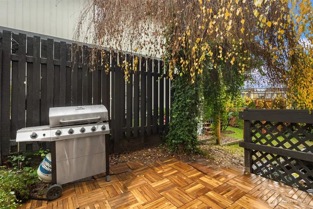 a view of a backyard with wooden fence