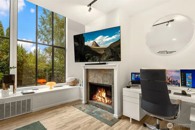 a living room with furniture a flat screen tv and a fireplace