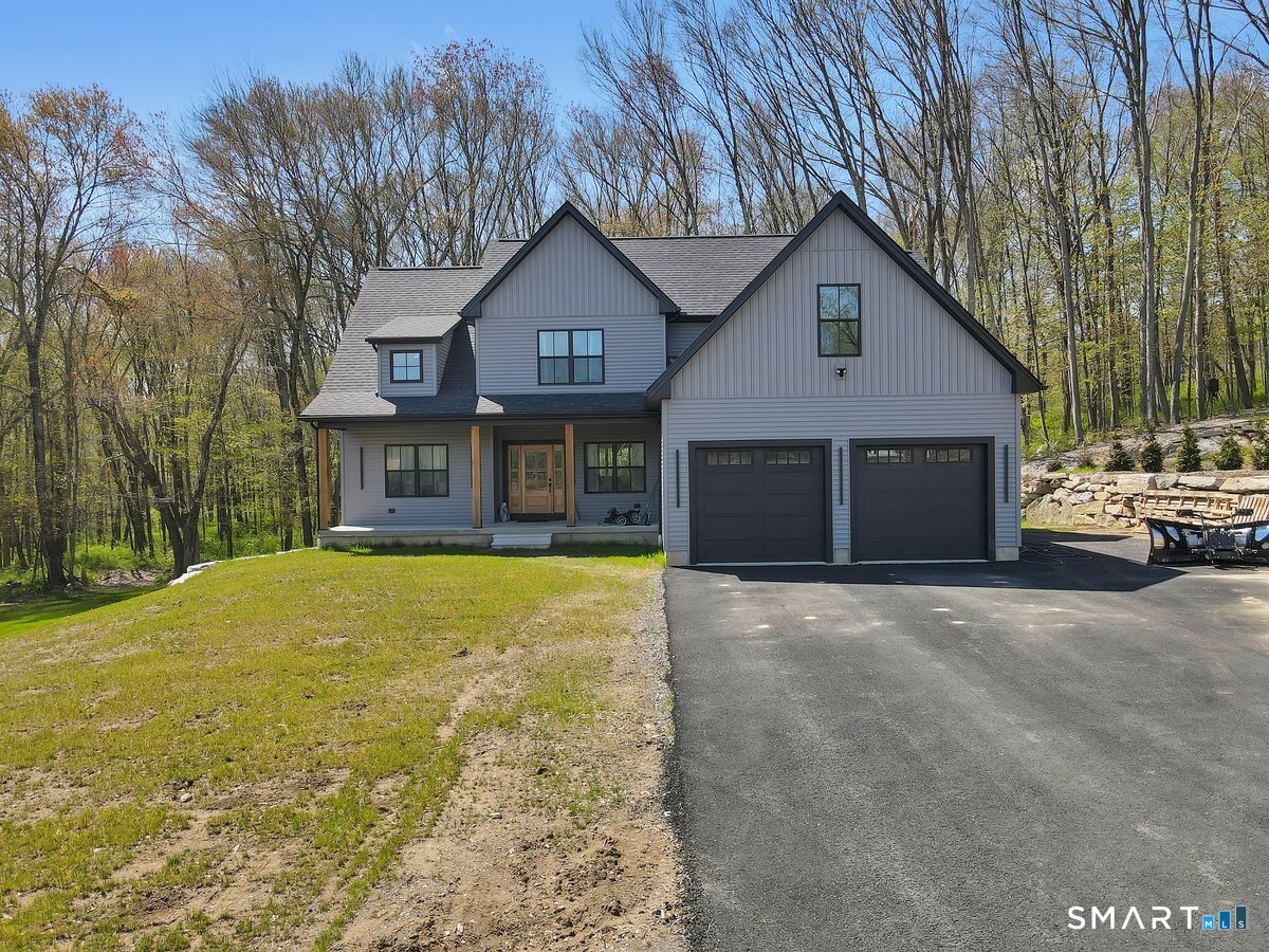 106 South Street Extension Coventry, CT 06238 - Photo 25 of 33 a front view of a house with a yard and garage