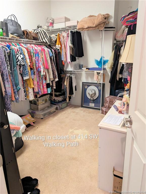 414 Southwest Walking Path, Unit 414 Stuart, FL 34997 - Photo 9 of 15 a view of walk in closet with clothes and shoes