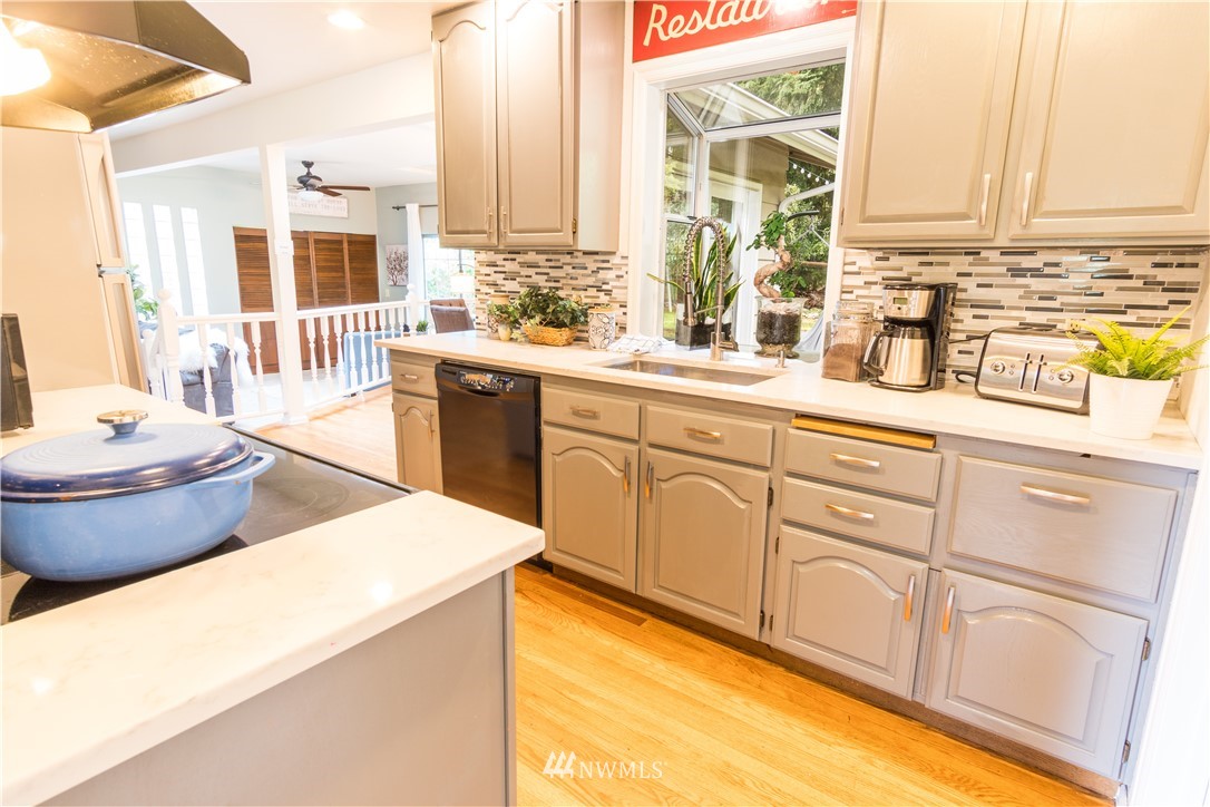 14634 Southeast 140th Street Renton, WA 98059 - Photo 5 of 35 a kitchen with sink cabinets and appliances