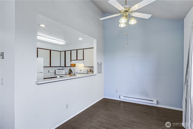 wooden floor in an empty room with a kitchen