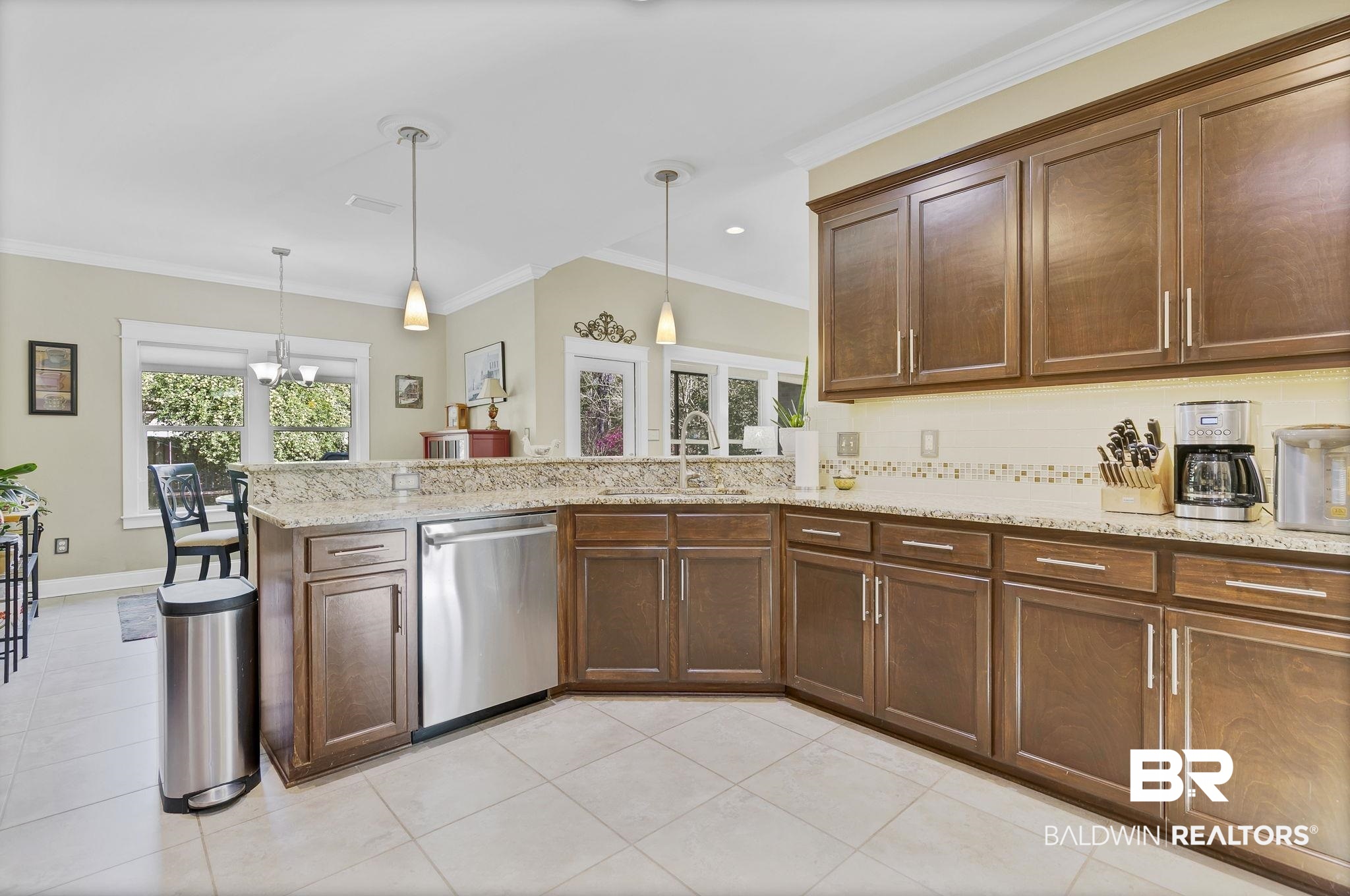 20105 Bunker Loop Fairhope, AL 36532 - Photo 27 of 65 Kitchen with pendant lighting, ornamental molding, a sink, a peninsula, and Bosch appliances