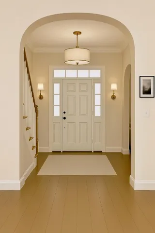 an empty room with wooden floor and mirror