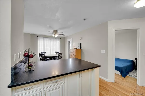 a kitchen with a refrigerator stove and white cabinets