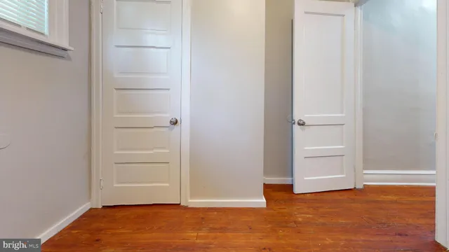 an empty room with wooden floor