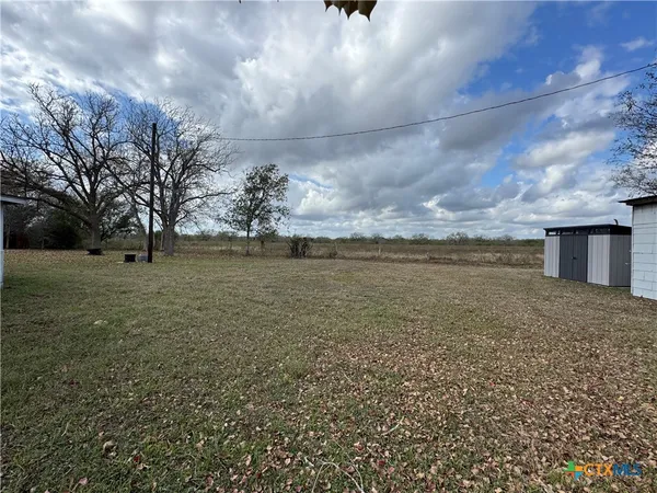 a view of a yard next to a building