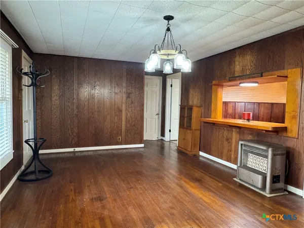 a view of a room with wooden floor and staircase