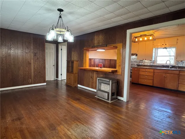 a view of a kitchen with granite countertop stainless steel appliances and wooden floor