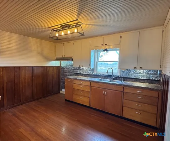 a spacious bathroom with a granite countertop sink and a mirror