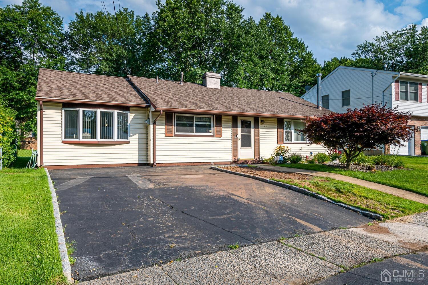 43 Kenmore Road Edison, NJ 08817 - Photo 1 of 19 a house that has a tree in front of the house