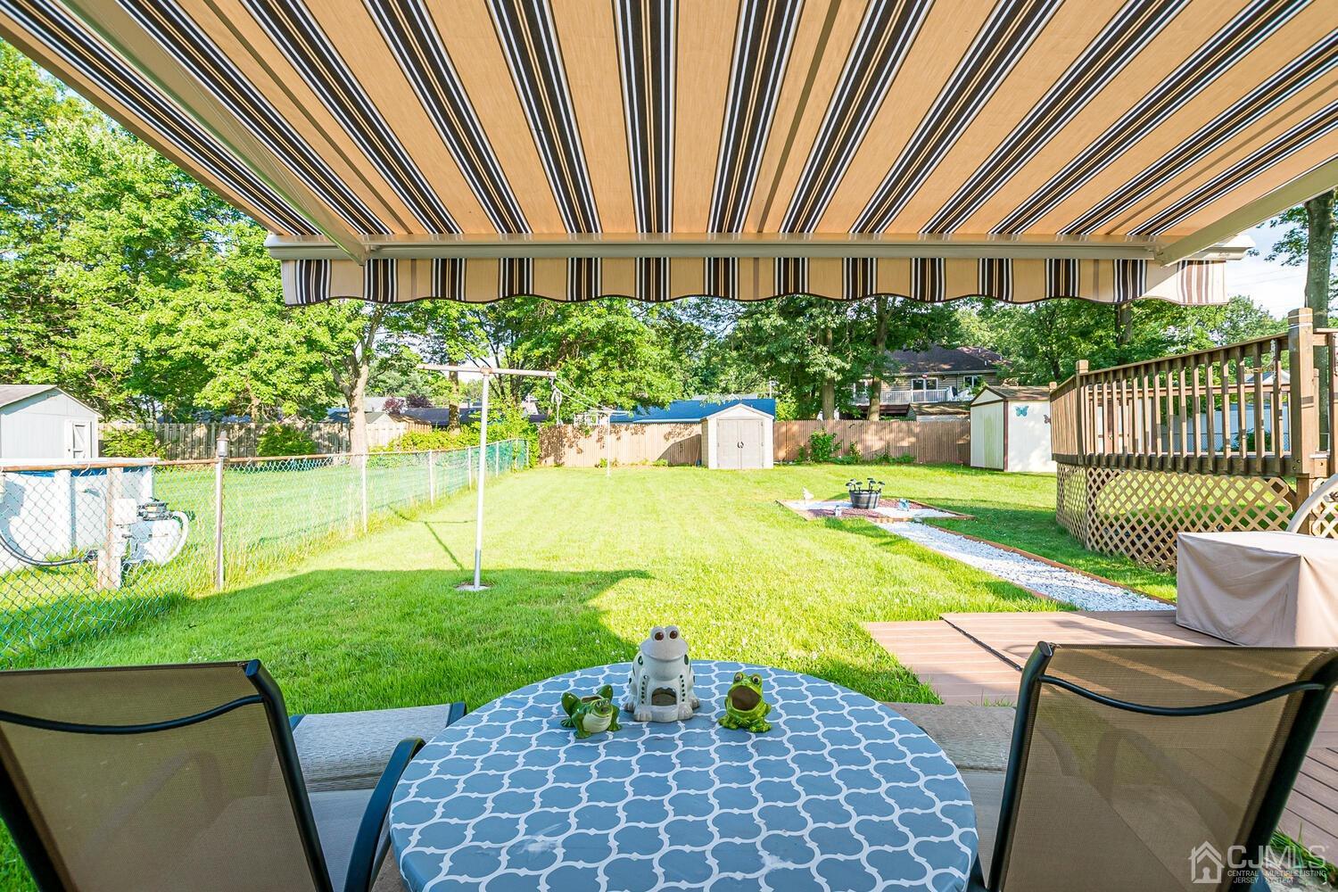43 Kenmore Road Edison, NJ 08817 - Photo 15 of 19 a view of a patio with couches plants and large trees