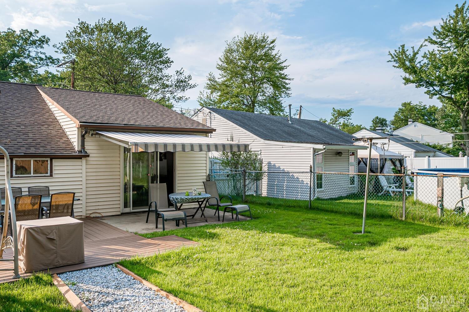 43 Kenmore Road Edison, NJ 08817 - Photo 17 of 19 a view of a house with backyard porch and sitting area