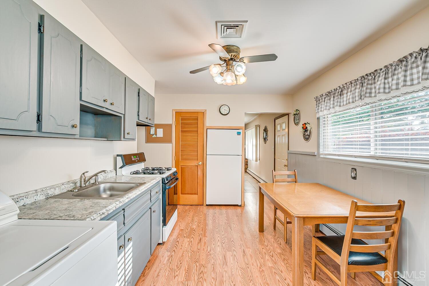 43 Kenmore Road Edison, NJ 08817 - Photo 8 of 19 a kitchen that has a lot of cabinets in it and wooden floors