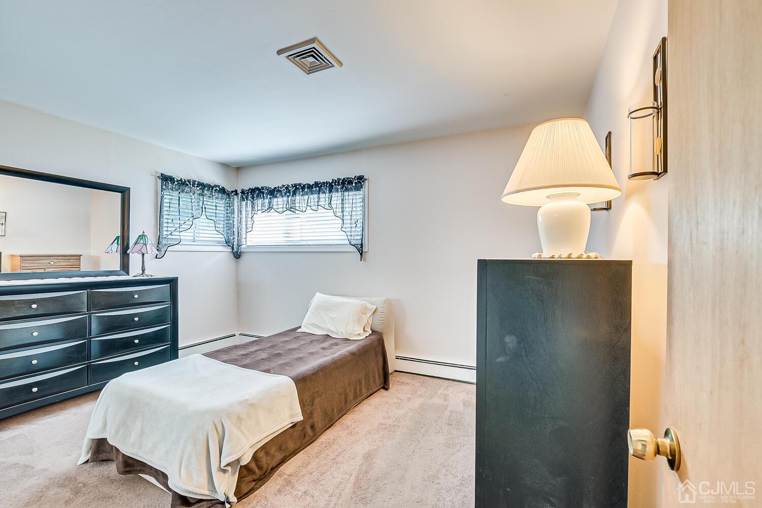 43 Kenmore Road Edison, NJ 08817 - Photo 10 of 19 a bedroom with a bed and a dresser