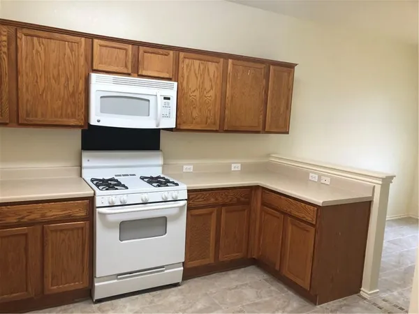 a kitchen with a stove microwave and sink