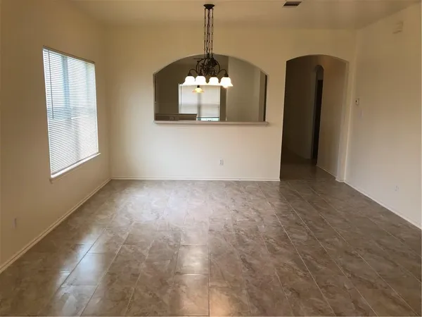 an empty room with windows and painted walls