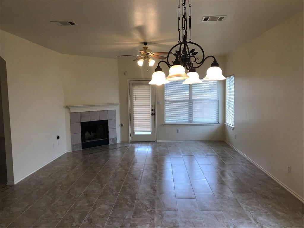 801 Ranchero Road Leander, TX 78641 - Photo 3 of 13 a view of a room wooden floor fireplace and window