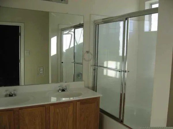 a bathroom with a sink a mirror and a shower