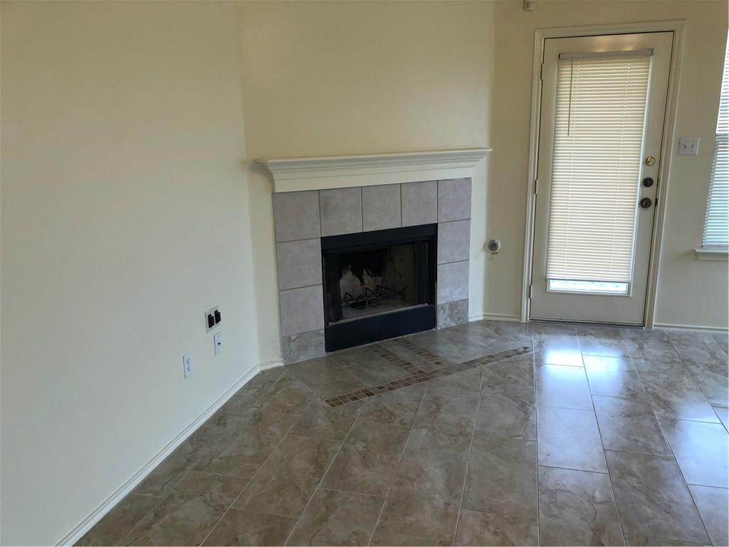 801 Ranchero Road Leander, TX 78641 - Photo 7 of 13 a view of empty room with wooden floor and fireplace