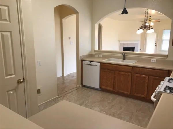 a spacious bathroom with a granite countertop sink a mirror and a vanity