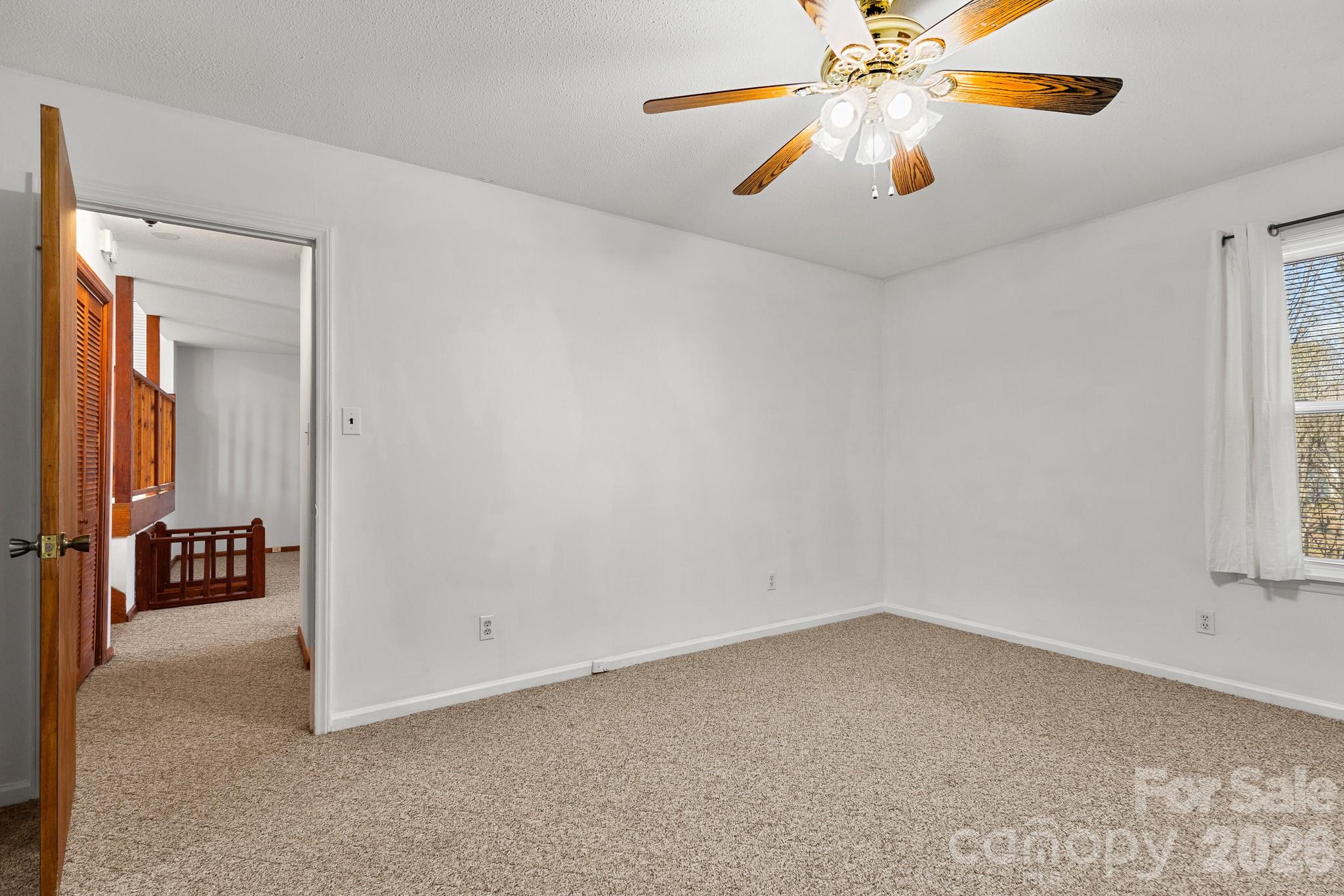 27077 Catamaran Drive Tega Cay, SC 29708 - Photo 14 of 28 an empty room with windows and fan