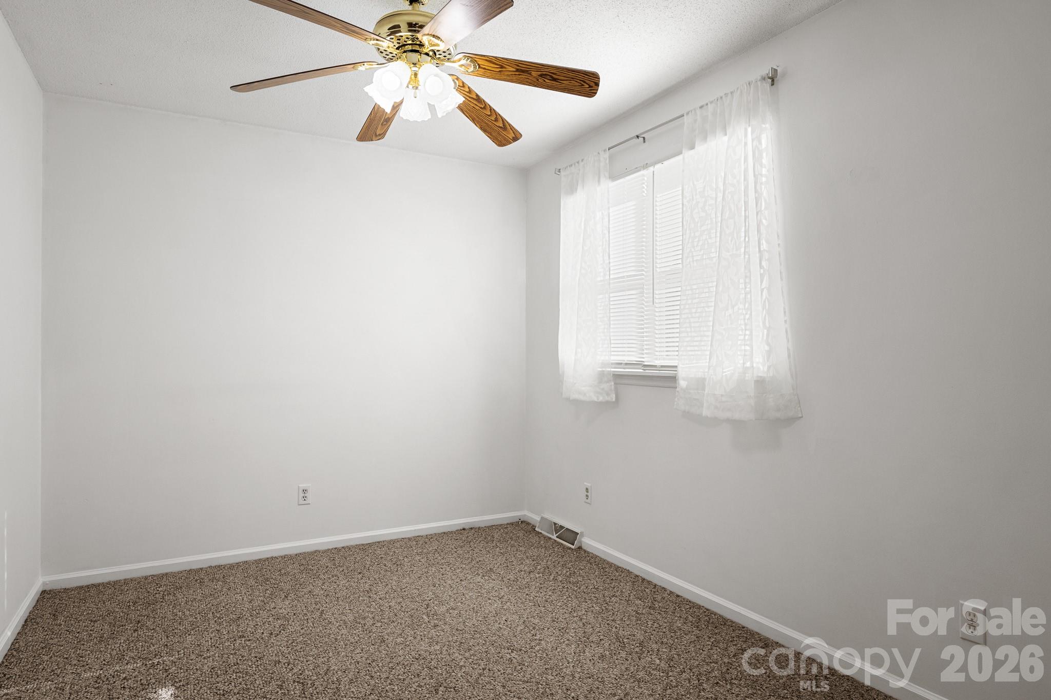 27077 Catamaran Drive Tega Cay, SC 29708 - Photo 19 of 28 an empty room with a window and a fan