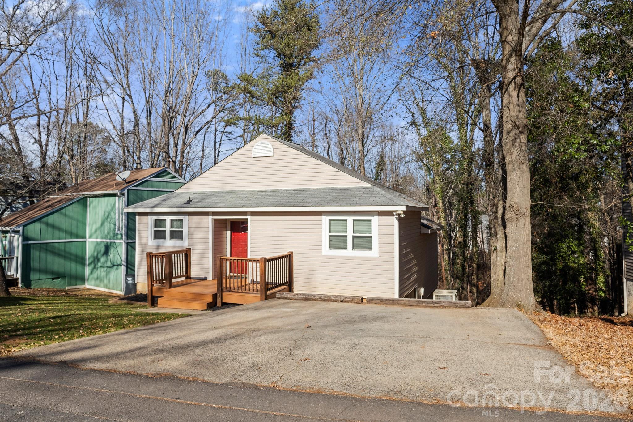 27077 Catamaran Drive Tega Cay, SC 29708 - Photo 2 of 28 a view of a house with a yard and large tree