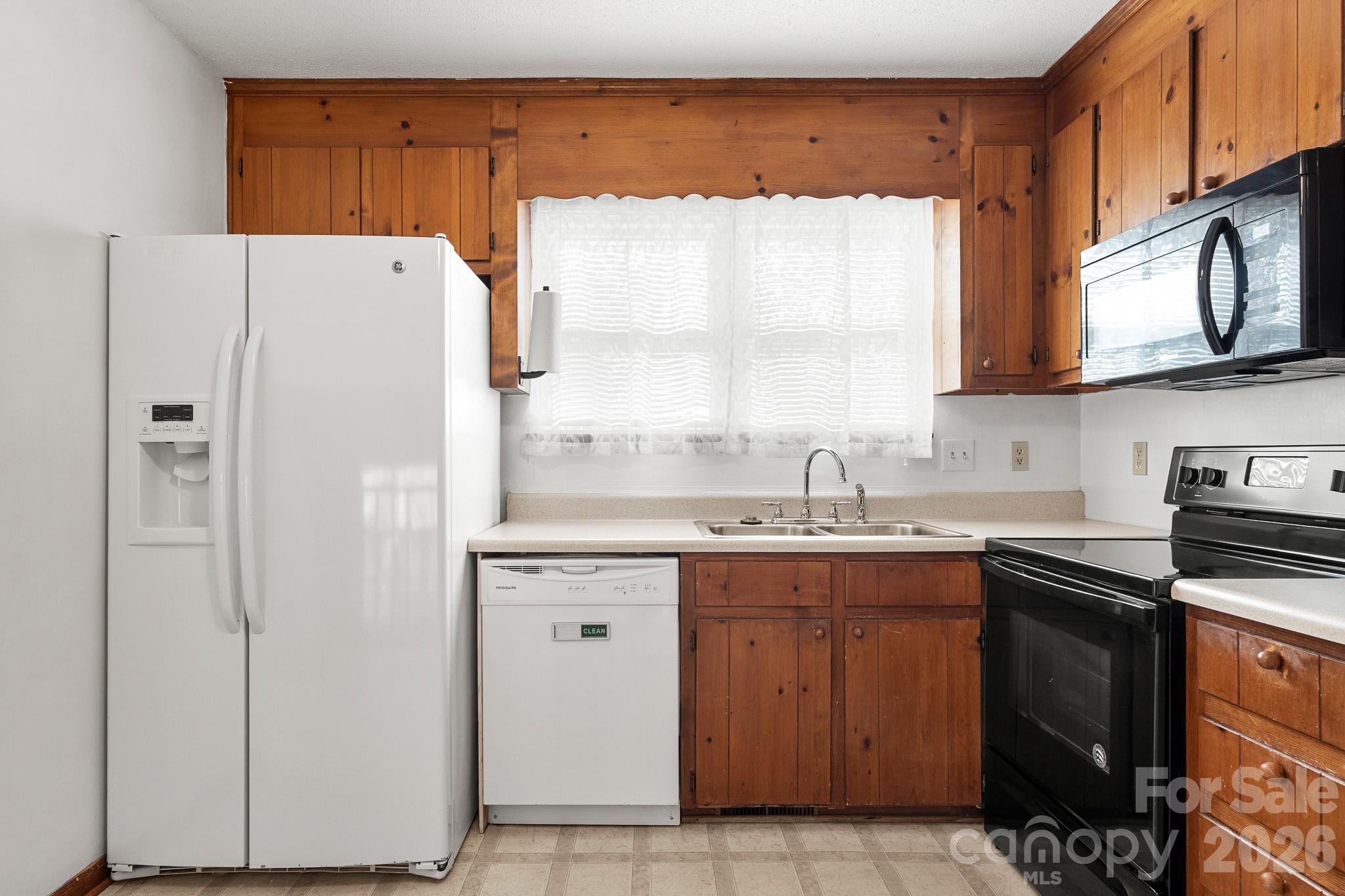 27077 Catamaran Drive Tega Cay, SC 29708 - Photo 8 of 28 a kitchen with a sink a refrigerator and a stove