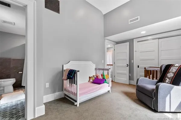a bedroom with a bed and a couch